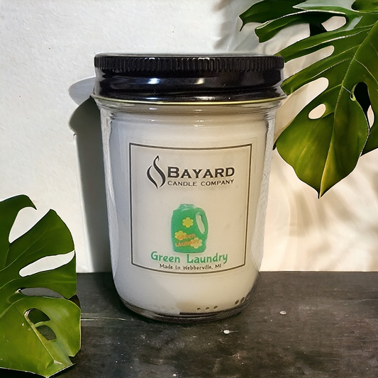 Green Laundry Soy Candle on wood table