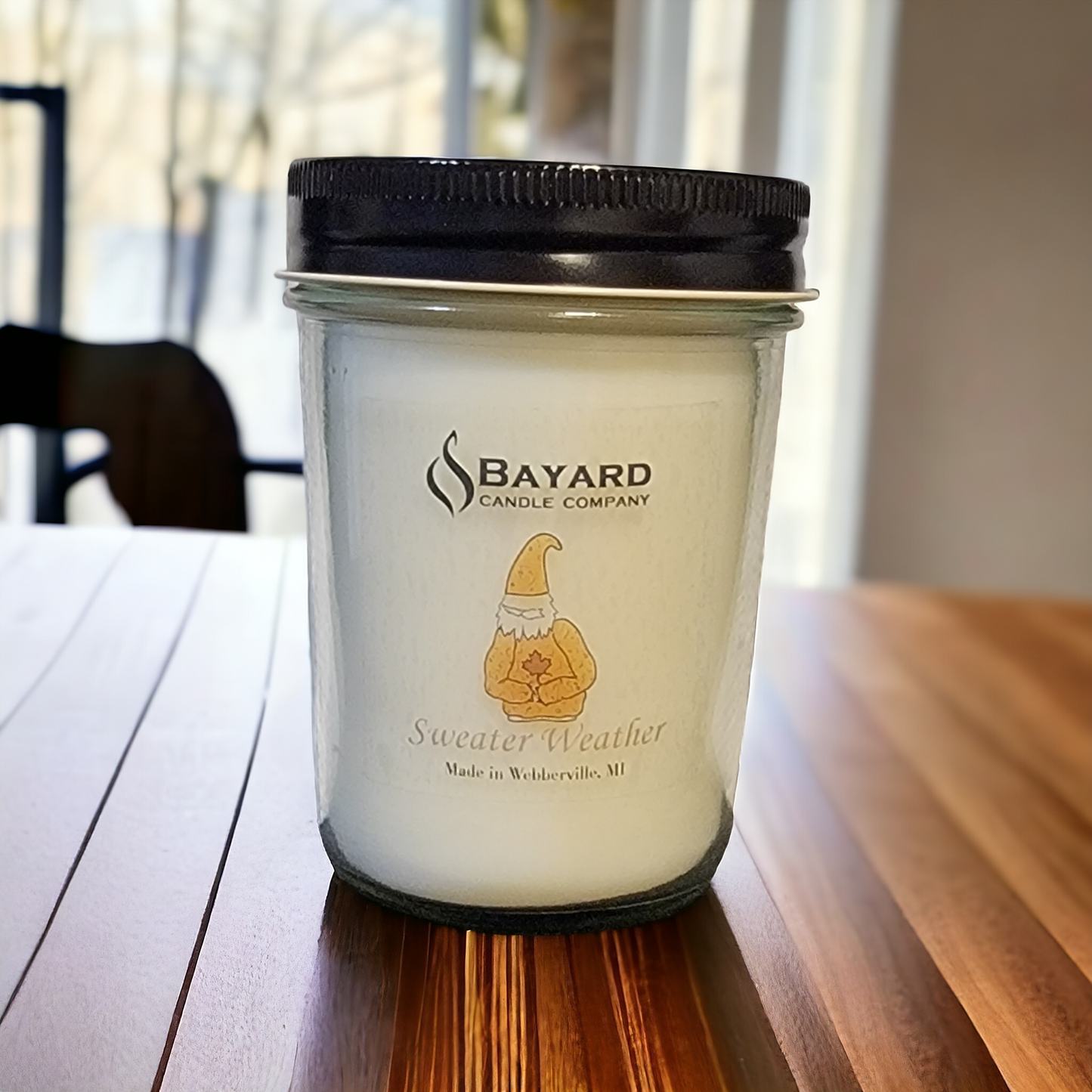 sweater weather soy candle on a wood table