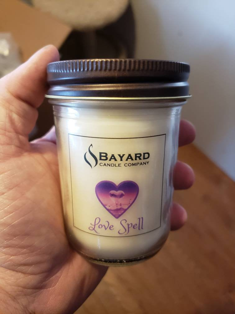 Love Spell Soy Candle in a hand